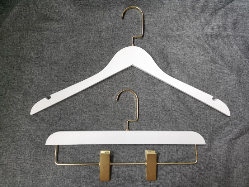 White coat hanger with gold metal
